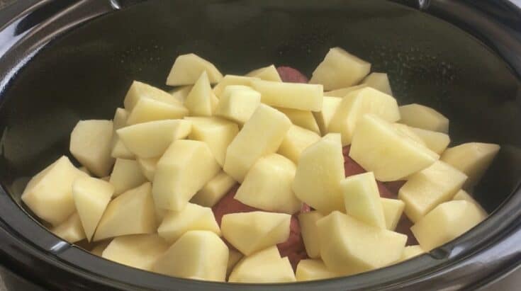 Peeled and sliced potatoes in a Crock Pot