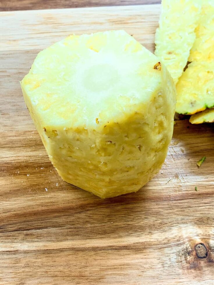 Cut up pineapple on a wooden cutting board