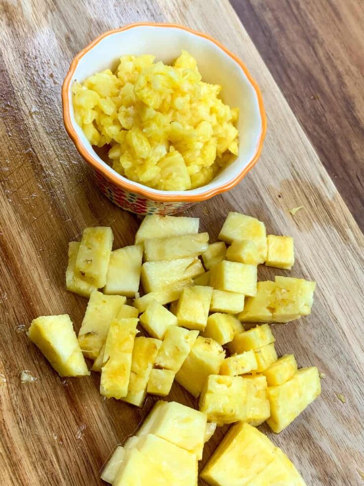 Chunks of cut pineapple on a cutting board