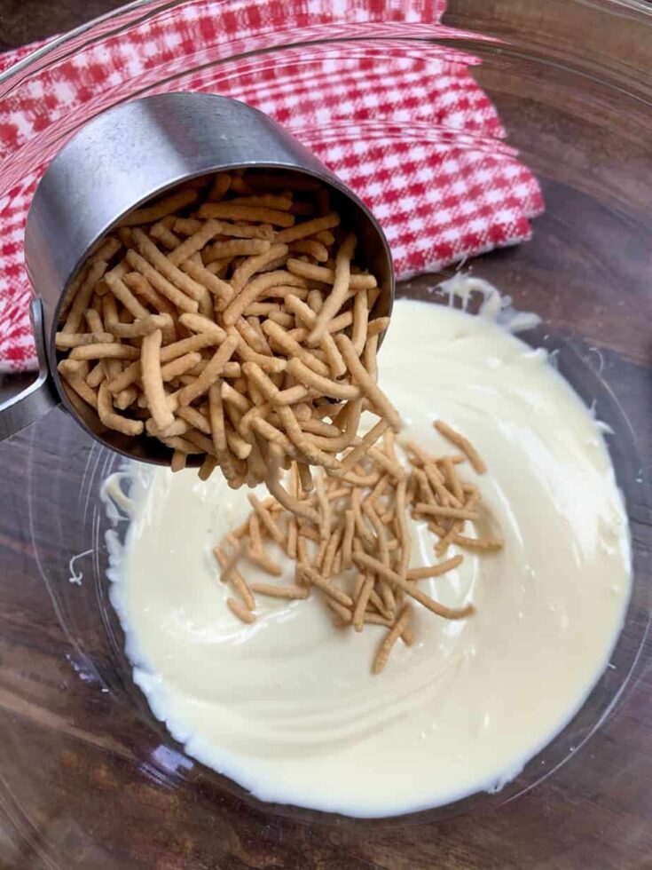 Pouring chow mein into melted white chocolate