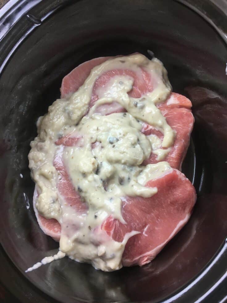 Pork chops in a slow cooker with mushroom soup on top