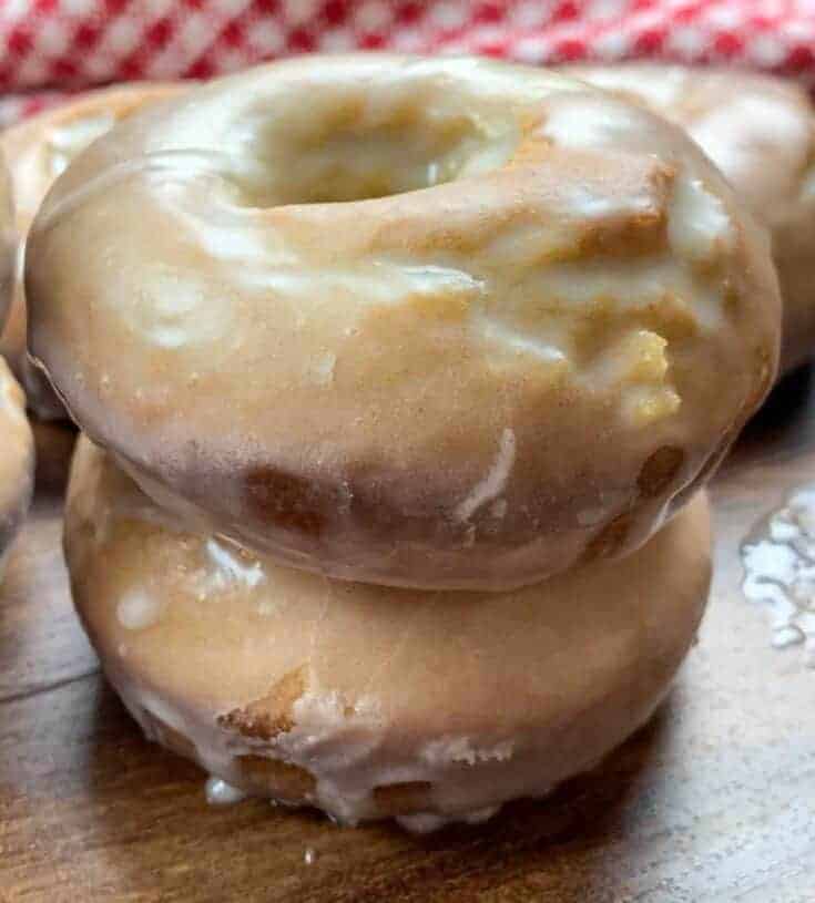 Two glazed donuts stacked on top of each other.