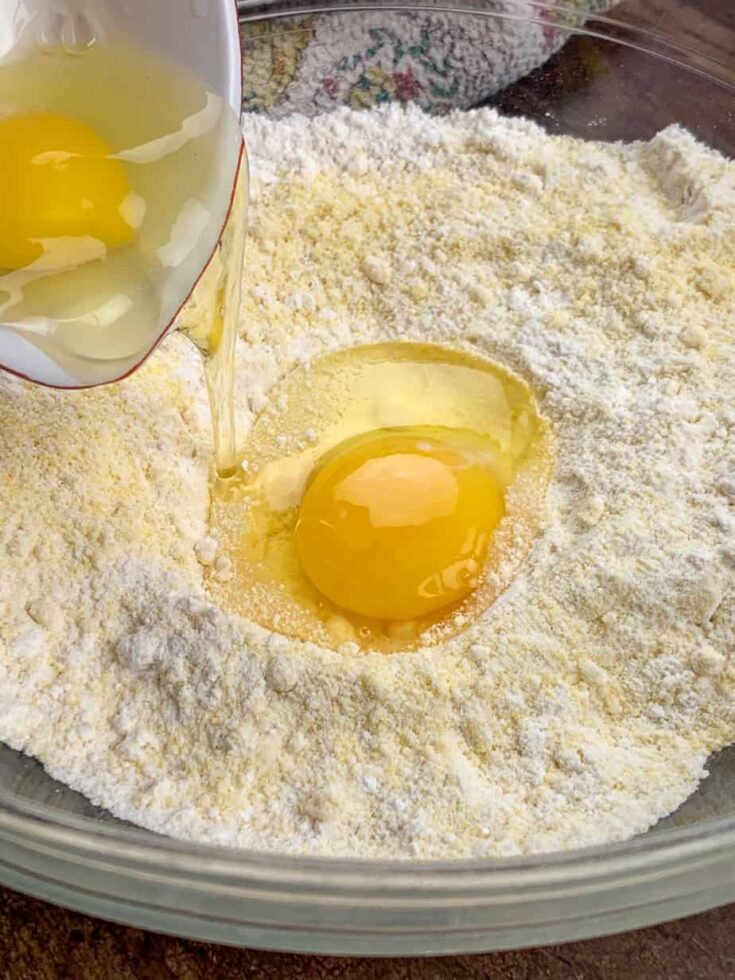 Jiffy Corn Muffin Mix with eggs in a glass bowl