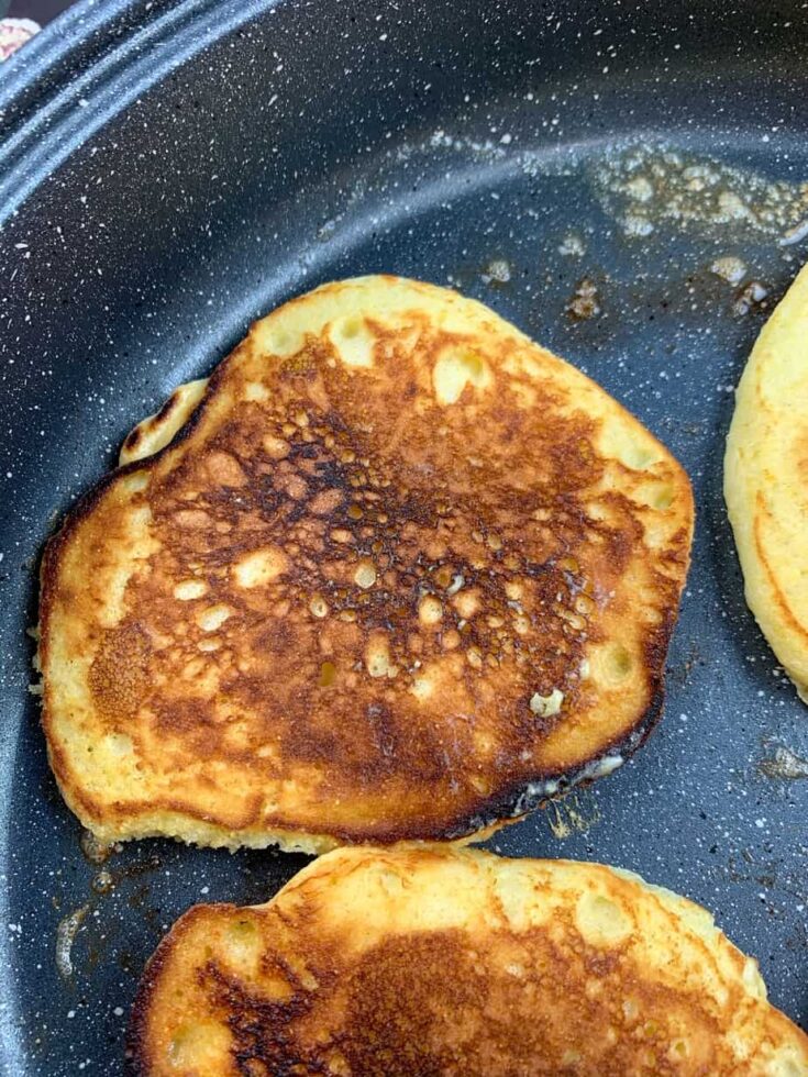 Cooking Jiffy Cornbread pancakes in a skillet