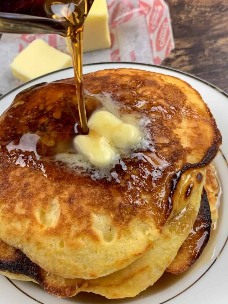 Pouring syrup on the fluffiest buttermilk pancakes