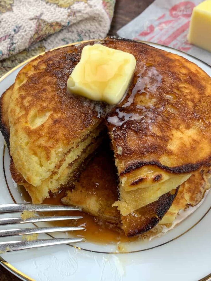 Jiffy Cornbread Pancakes on a plate with butter on top 