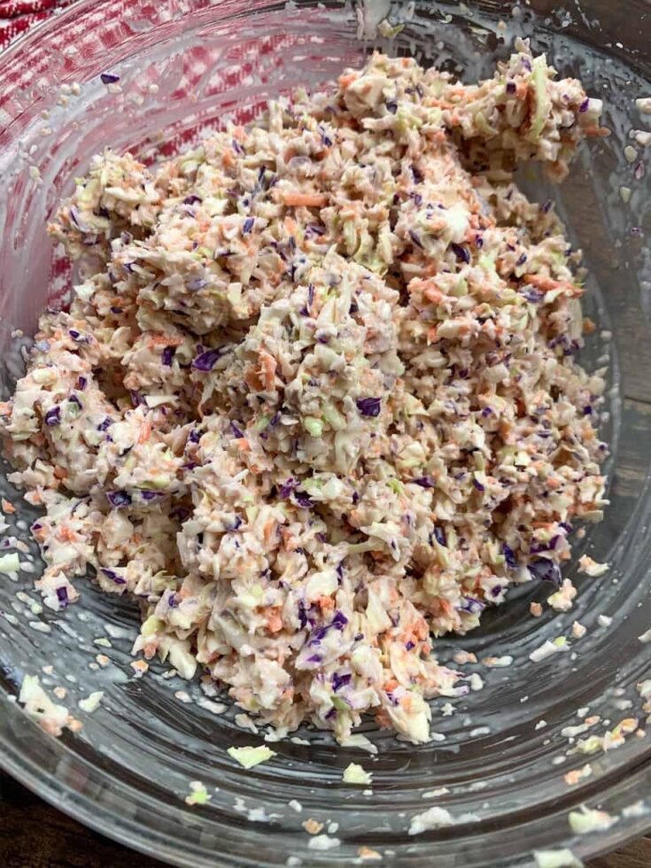 Mixed coleslaw in a glass bowl with mayonnaise, vinegar, and sugar