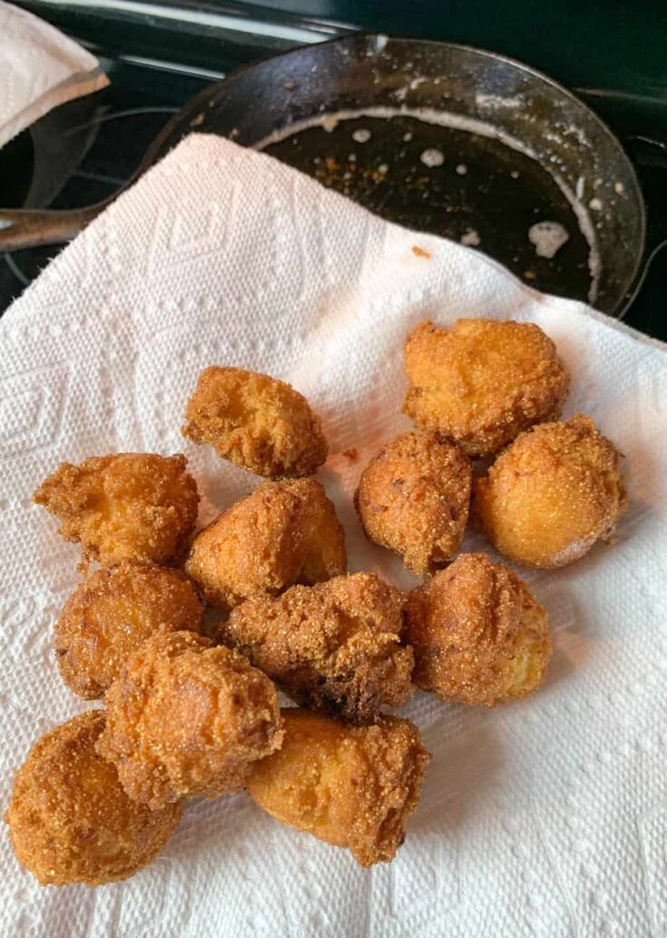 Hush puppies draining grease on a paper towel. 