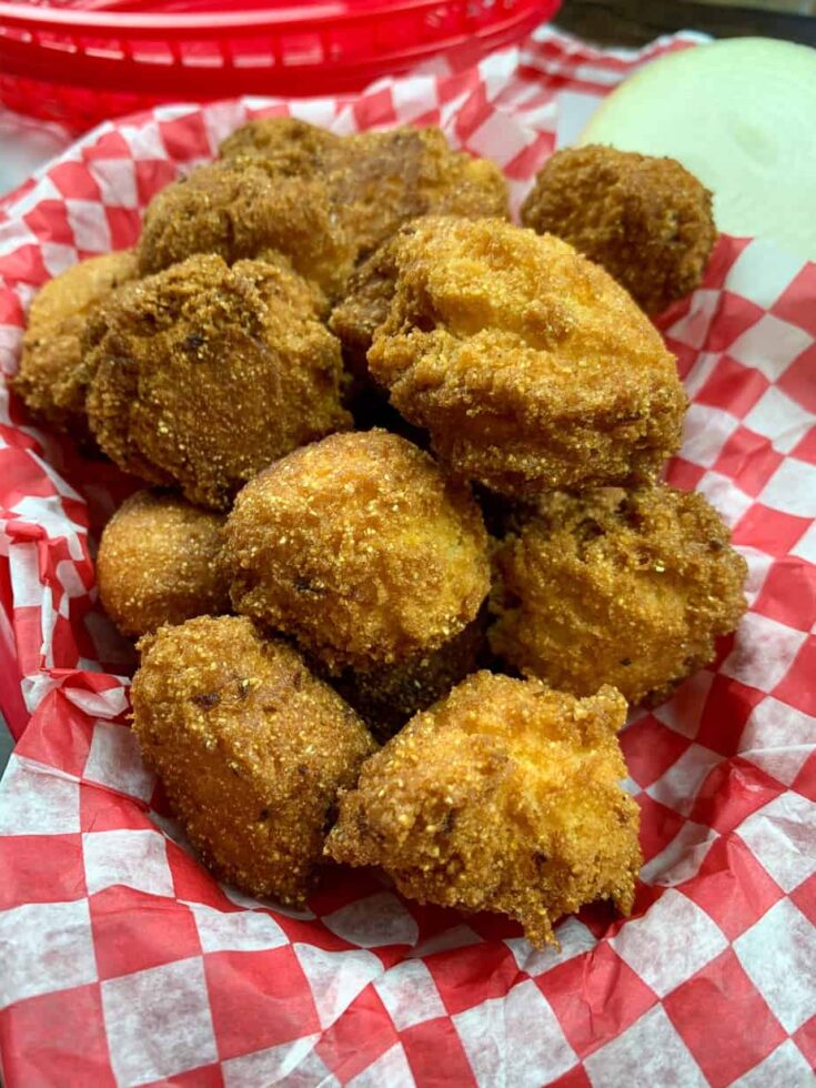 Southern hush puppies in a basket with red and white checkered tissue.