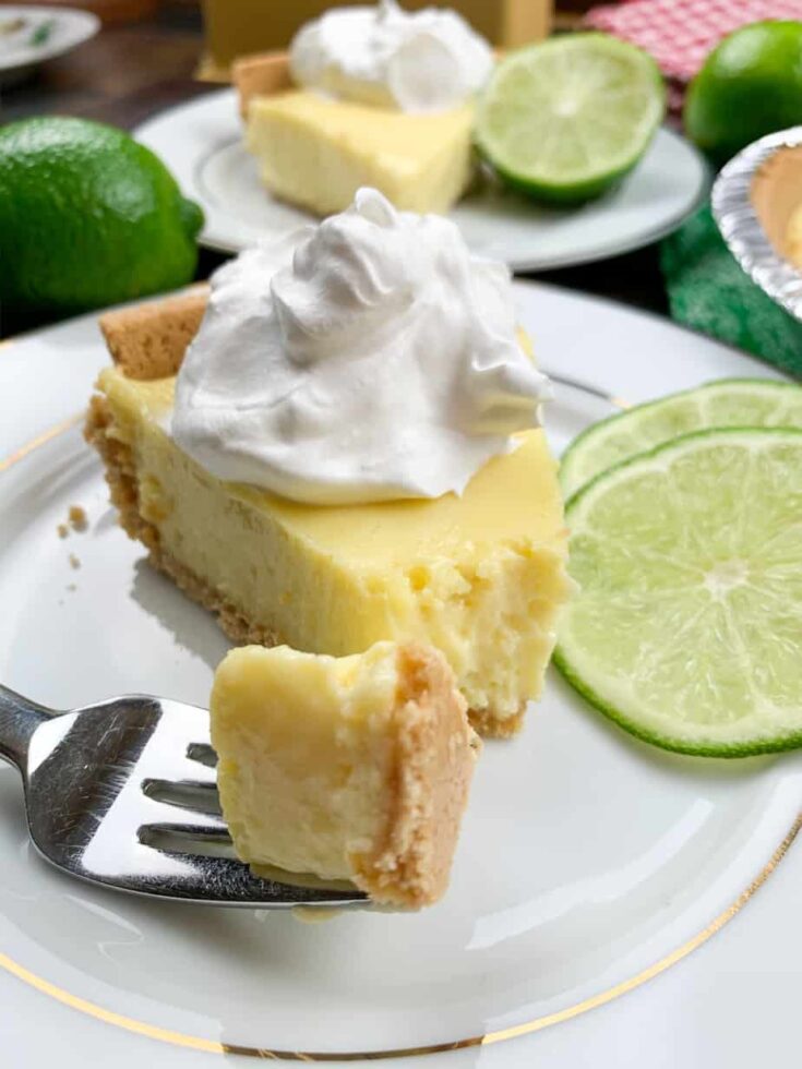 A piece of key lime pie on a plate with a fork