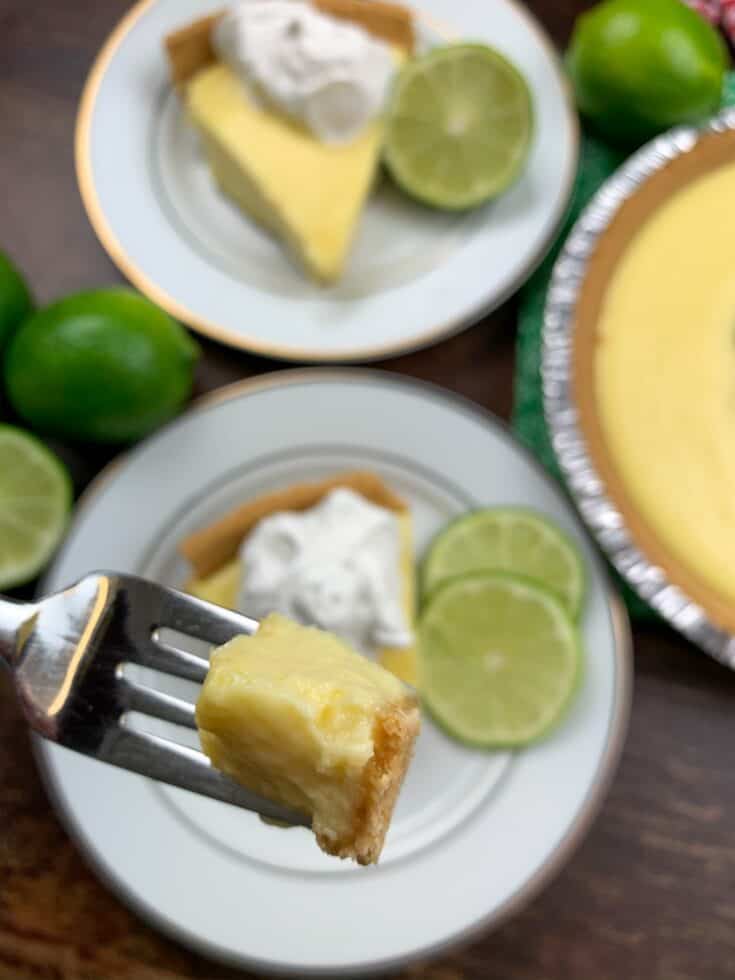 A bite of key lime pie on a fork