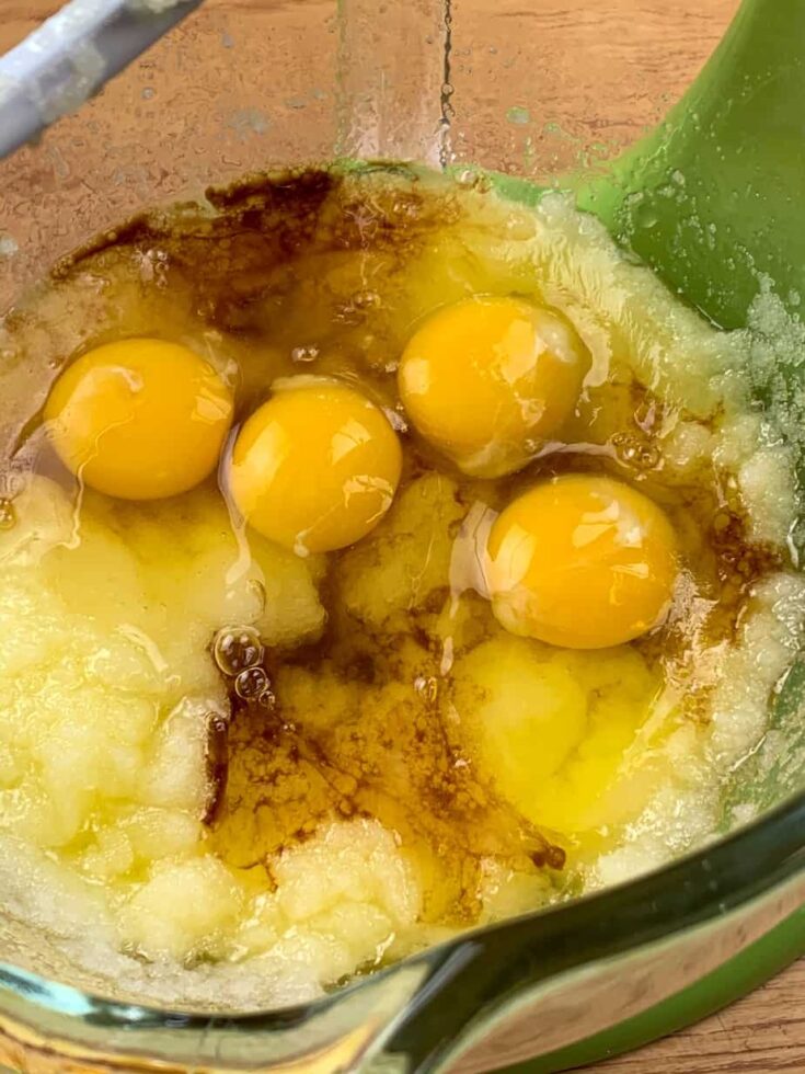 Eggs, vanilla extract, butter, and sugar in a large glass bowl.