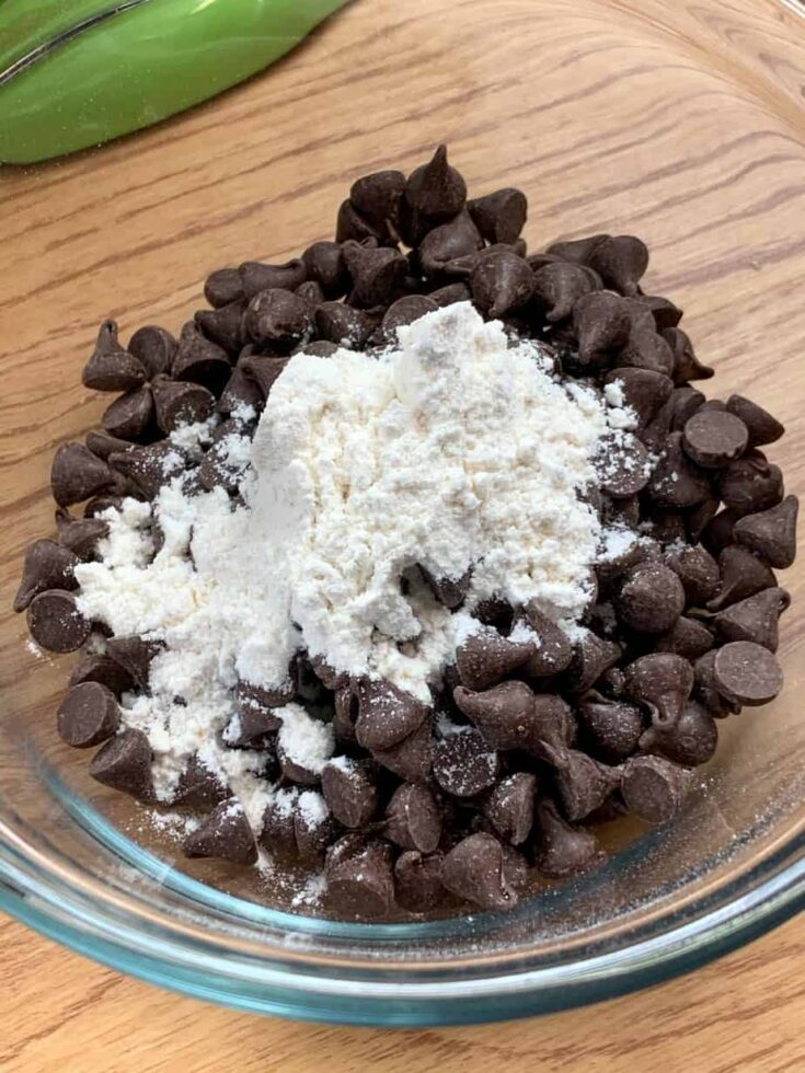 Chocolate chips and flour in a small glass bowl