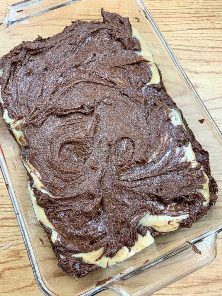 Buckeye brownie batter on top of sweetened condensed milk and peanut butter layers.