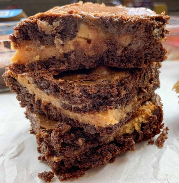 Two buckeye brownies with sweetened condensed milk stacked on top of each other. 