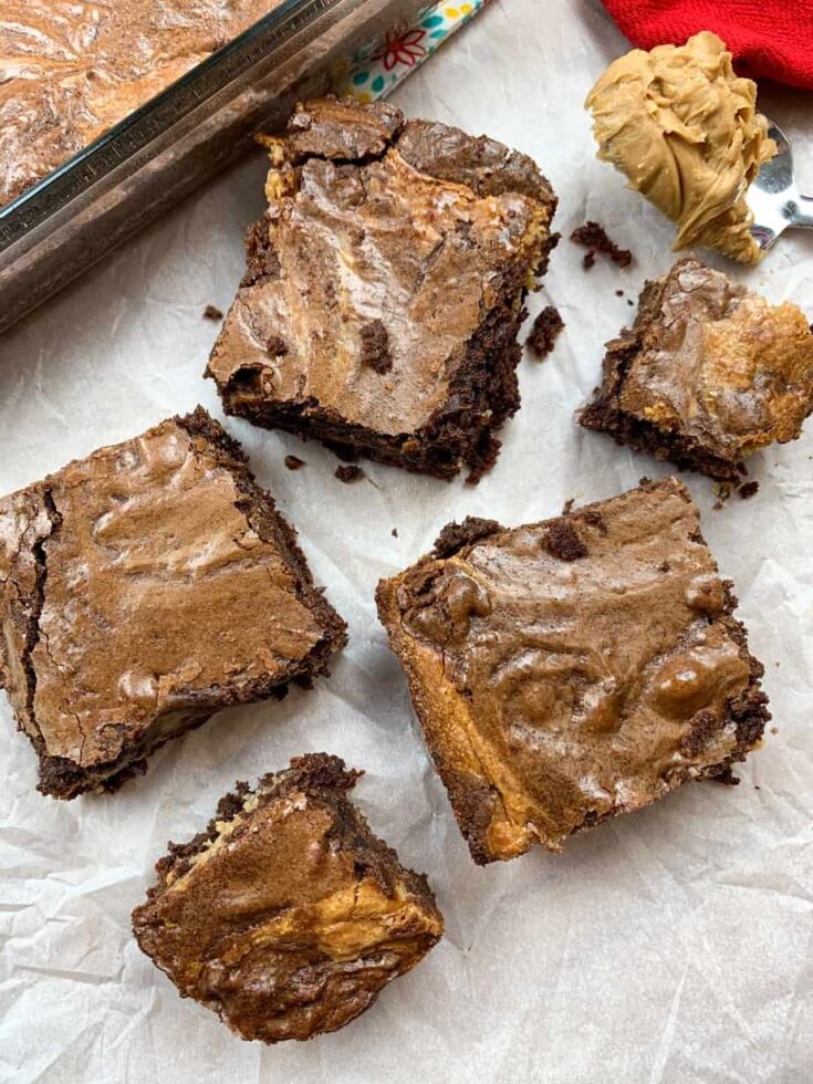 Five buckeye brownies on top of white parchment paper.