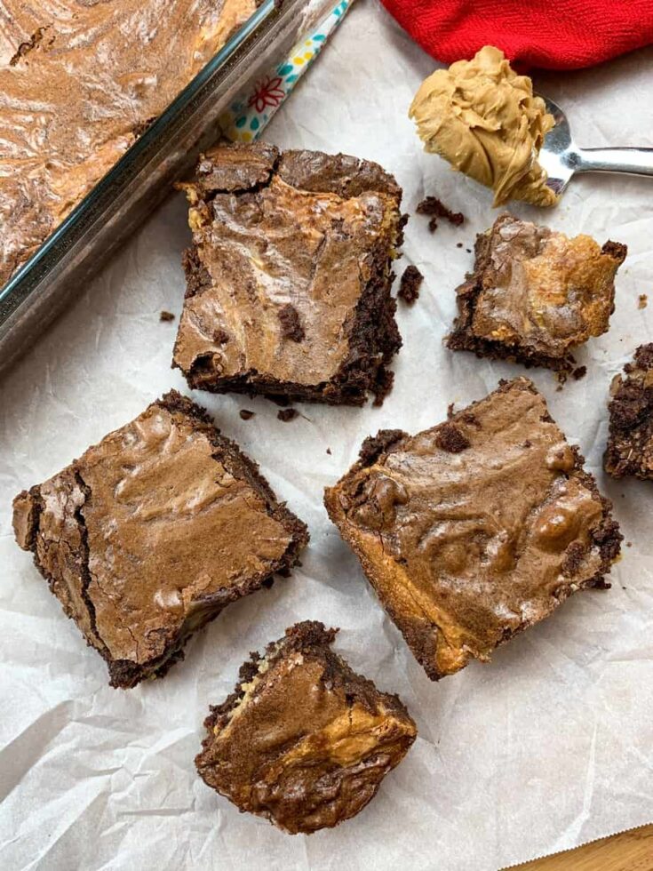 Brownie squares on a piece of white parchment paper