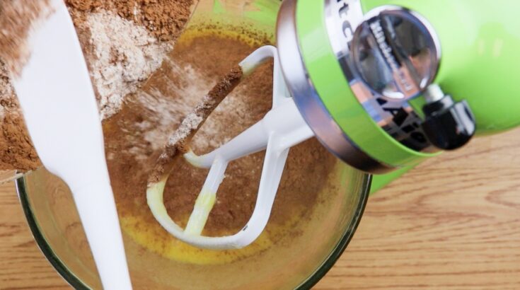 Adding the flour mixture to the mixer for brownies.